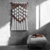 Handmade fiber art wall hanging featuring intricate patterns and vibrant colors.