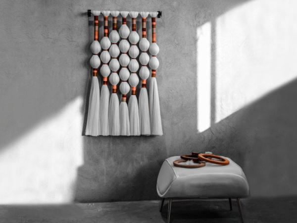 Handmade fiber art wall hanging featuring intricate patterns and vibrant colors.